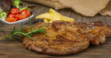 Veal cutlet from Avila, Spain with potatoes and vegetables juicy and tender clipart