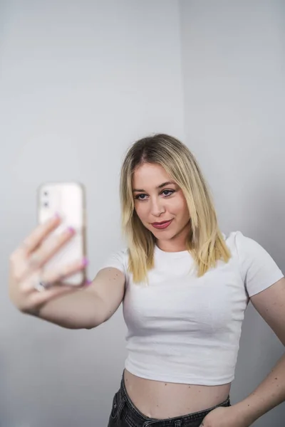 Young Caucasian Female Spain Taking Selfie Phone White Wall — Stockfoto