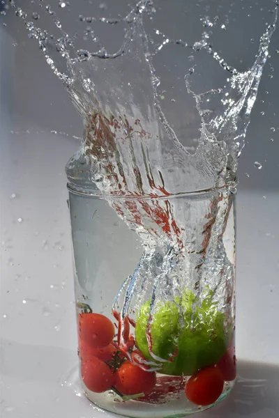 Pionowe Ujęcie Warzyw Wpadające Szklanego Słoika Powodujące Rozpryski Wody — Zdjęcie stockowe
