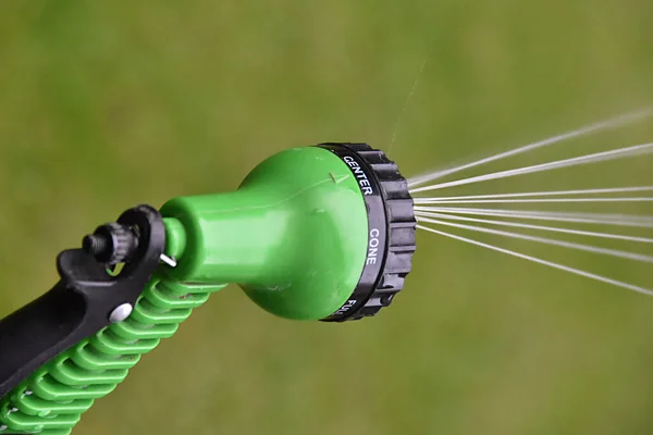 Closeup Shot Sprinkler Watering Grass Blurred Green Background — Stock Photo, Image