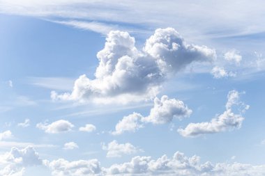 A blue sky contrasted with white clouds clipart