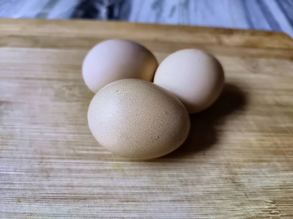 Primer Plano Tres Huevos Marrones Una Tabla Madera —  Fotos de Stock