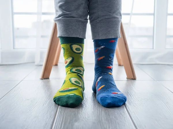 Closeup Two Different Artistic Socks Feet Avocados Left Blue Space — Stock Photo, Image