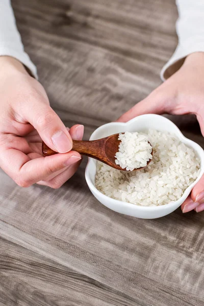 Closeup Hands Holding Wooden Spoon Rice Grains Bowl — Stock Photo, Image