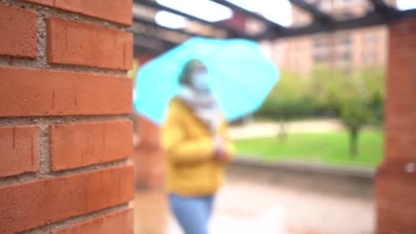 Young Caucasian Female Mask Holding Umbrella Walking Street — ストック動画