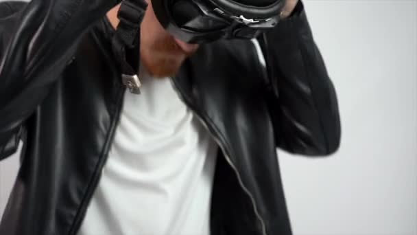 Young Caucasian Male Leather Jacket Putting Helmet White Wall — Stock Video