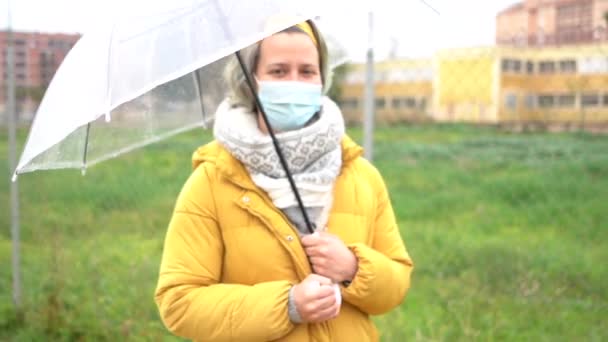 Young Caucasian Female Mask Holding Umbrella Walking Street — Stock Video