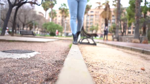 Een Vrouw Spijkerbroek Laarzen Lopend Een Park — Stockvideo