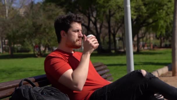 Young Caucasian Male Sitting Bench Drinking Coffee Enjoying Weather — Video