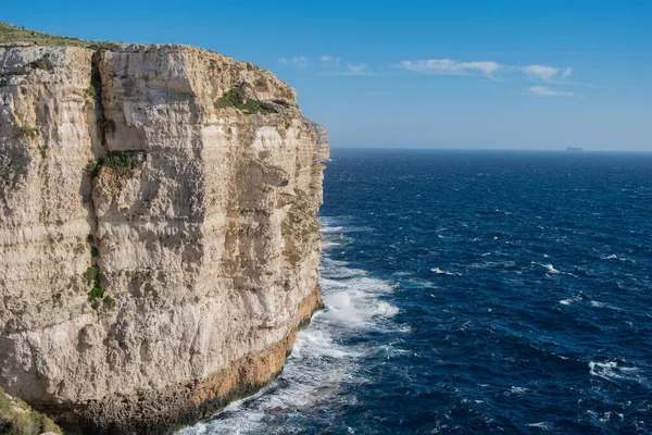 Rabat Malta 2021年2月10日 マルタのミガ フェラの海岸線の隣に堆積岩の層を示す石灰岩の切り立った崖 崖や青い空の底を打つ波 — ストック写真
