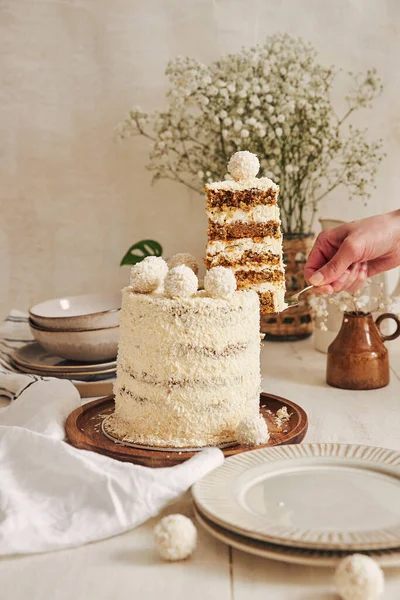 トレイにココナッツフレークがスライスされたクリーミーな白いケーキ ラファエロのケーキのスライス — ストック写真