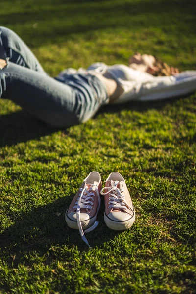 Vertical Shot Pink Shoes Next Beautiful Caucasian Woman Lying Grass — Stock Photo, Image