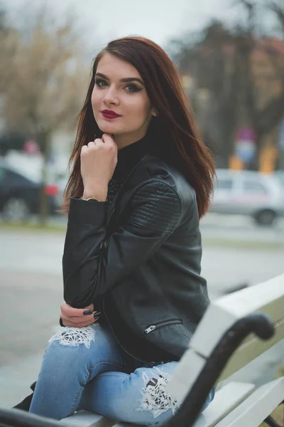 Vertical Shot Young Brunette Female Leather Coat Posing Sitting Bench — ストック写真