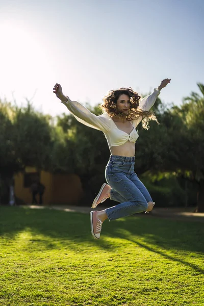 Vertical Shot Beautiful Spanish Caucasian Woman Wearing Top Jeans Jumping — 스톡 사진