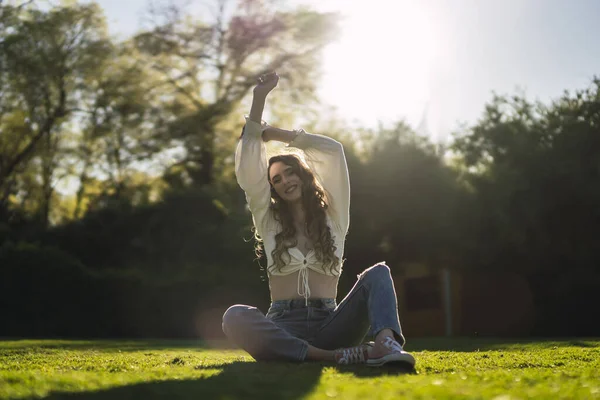 Beautiful Caucasian Woman Spain White Top Jeans Sitting Grass Stretching — 스톡 사진
