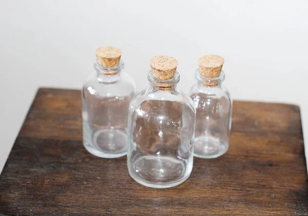 Closeup Three Glass Bottles Corks Wooden Table — Stock Photo, Image