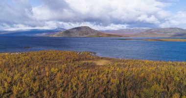 Tornetrask, aerial,, drone shot, towards a arctic lake, near Abisko, on a partly sunny day, in Lappland, Norrbotten, Sweden clipart