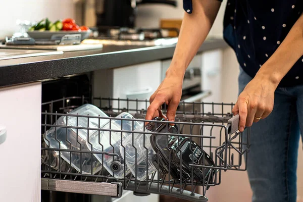 Closeup Woman Putting Plastic Containers Dishwasher Kitchen Indoors — Stock Photo, Image