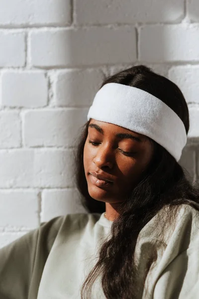 Charming Young African Female Wearing White Headband Leaning White Wall — Stock Photo, Image