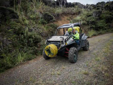 AUCKLAND, NEW ZEALAND - Apr 15, 2021: View of Polaris rzr xp 900 efi UTV utility terrain vehicle equipped with agricultural pump sprayer clipart