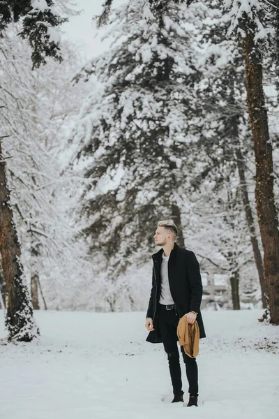 Handsome Young Man Black Winter Outfit Walking Snowy Forest Path — стоковое фото