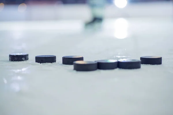 stock image A selective focus shot of ice hockey pucks on the ice