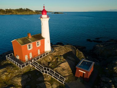 An aerial shot of the Fisgard Lighthouse surrounded by the sea in  Canada clipart