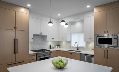 VANCOUVER, CANADA - Mar 07, 2020: Close up photograph of a modern interior designed kitchen of a duplex unit for sale. clipart