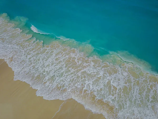 一张鸟瞰沙滩的照片 海滩上有浪花飞扬的大海 — 图库照片
