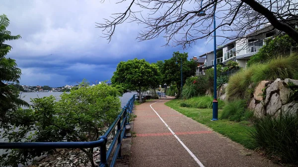 Narrow Pathway Surrounded Greenery Buildings Sea Stormy Sky Background — Foto de Stock