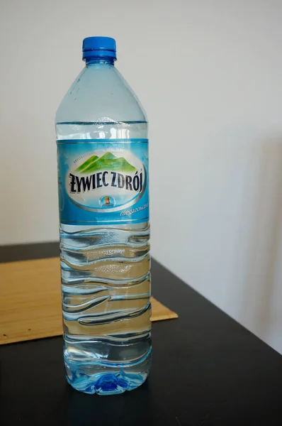 stock image POZNAN, POLAND - Sep 05, 2013: Bottled still mineral water Zywiec Zdroj on the wooden table