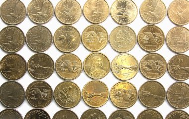 A top view of Sacagawea US golden dollars from above. Straight down background many coins. clipart
