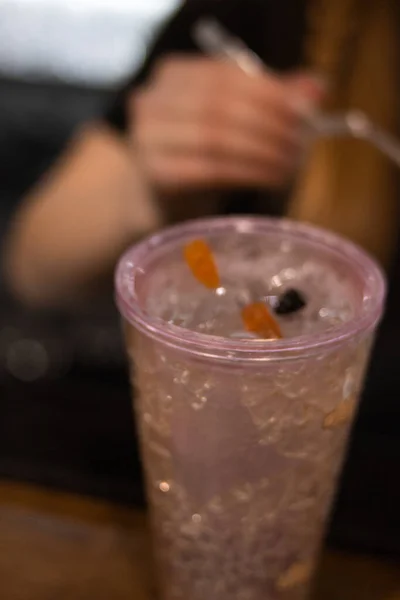 A vertical shot of an icy drinks with gummy bears on top