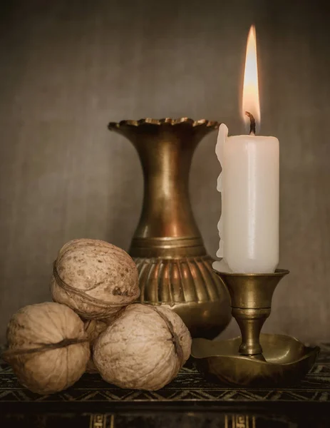 Eine Vertikale Aufnahme Einer Komposition Einer Brennenden Kerze Mit Walnüssen — Stockfoto