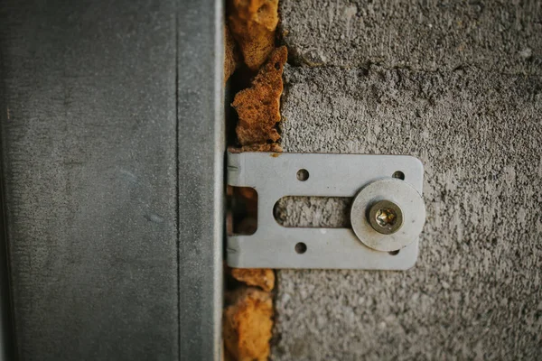 水泥墙上生锈的门铰链的特写镜头 — 图库照片