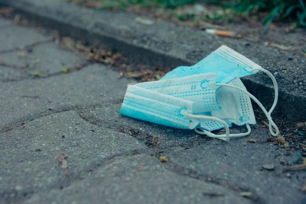 Closeup Used Blue Face Mask Thrown Sidewalk — Stock Photo, Image