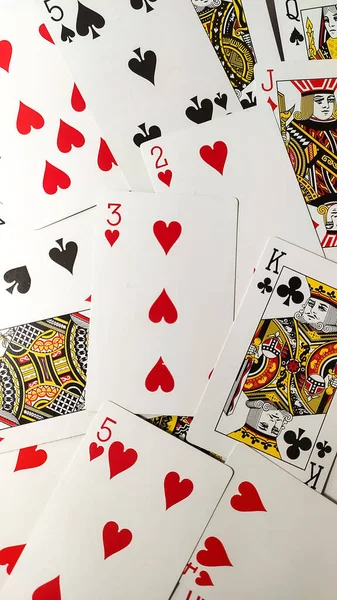 A vertical shot of the scattered deck of playing cards