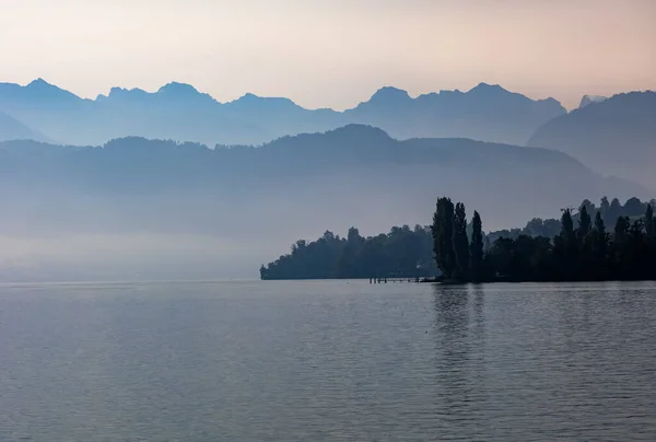 Beautiful Shot Calm Sea Evening Trees Silhouettes Distant Hills — Stock Photo, Image