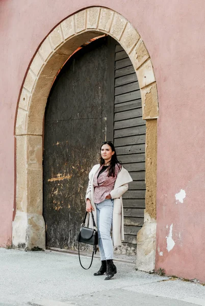 Stylová Mladá Brunetka Chorvatska Stojí Před Starými Obloukovými Dřevěnými Dveřmi — Stock fotografie