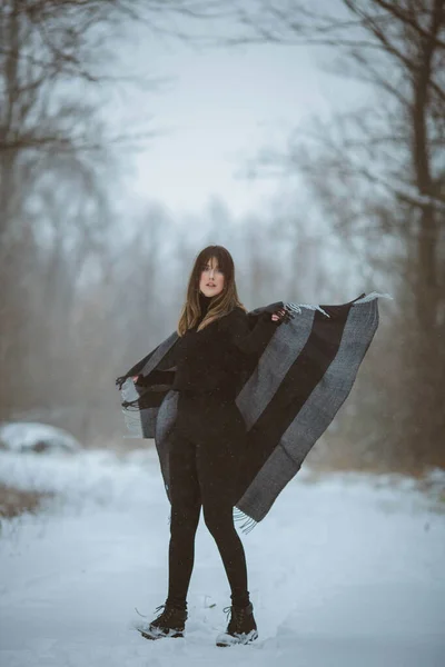 Young Woman Moving Her Oversized Blanket Scarf While Standing Snowy — Photo