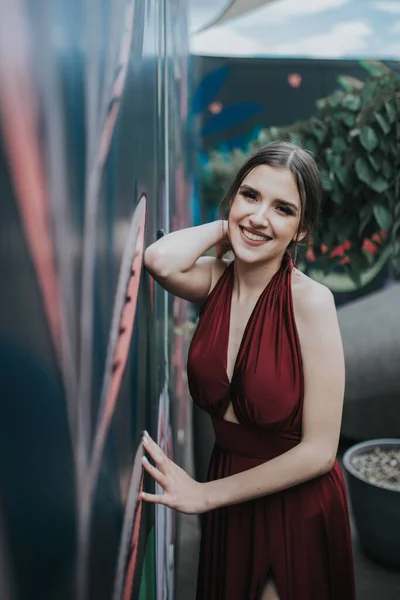 Shallow Focus Cheerful Woman Wearing Red Dress Leaning Wall Outdoor — стоковое фото