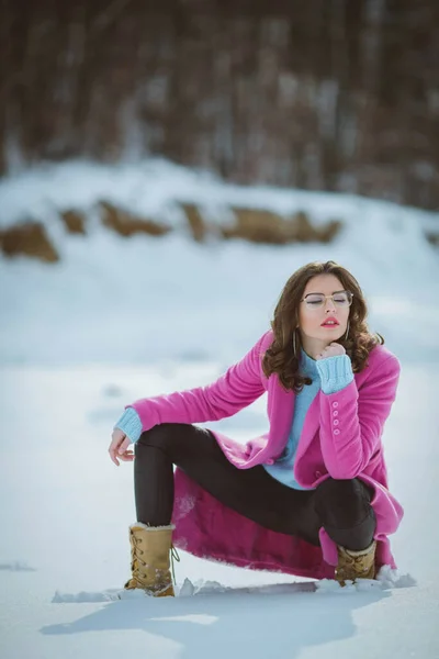 Young Thoughtful Brunette Girl Eyeglasses Kneeling Snow Forest Wearing Pink — Stock Fotó