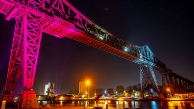 The Tees Transporter Bridge under the colorful lights at night in Middlesbrough, United Kingdom clipart