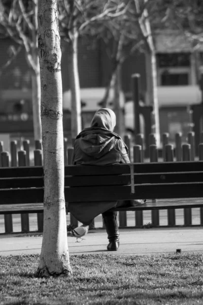 Uma Escala Cinza Uma Mulher Sentada Banco Urbano Barcelona — Fotografia de Stock