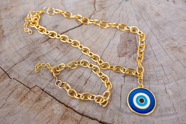 Closeup Shot Gold Necklace Eye Amulet Wooden Background — Stock Photo, Image