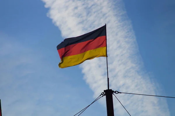 Tysk Flagga Vindar Vinden Framför Kontrail Och Blå Himmel Bakljus — Stockfoto