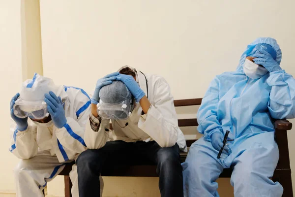 A group of exhausted medical personnel during the COVID-19 pandemic