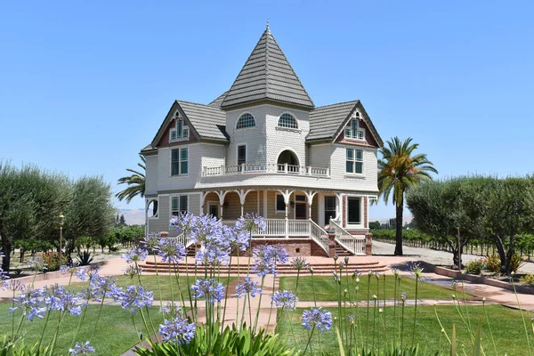a luxurious victorian architecture home with purple flowers at a winery in Livermore, California