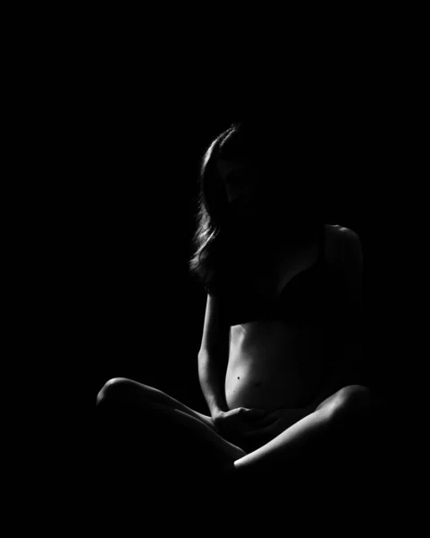 Grayscale Pregnant Woman Underwear Sitting Dark Holding Her Belly — Stock Photo, Image