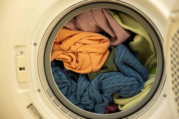 Colorful laundry loaded in the washing machine